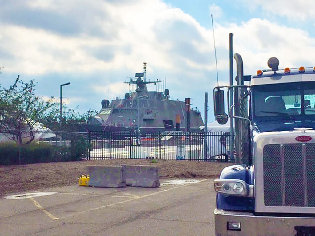 Commercial marine fueling services with fuel tanker supplying vessels at dock