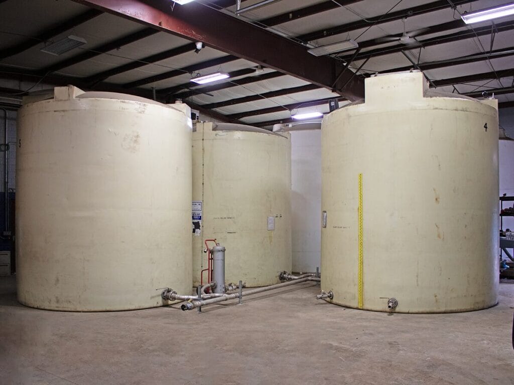 Diesel exhaust fluid tanks and pumps for commercial fleet fueling operations