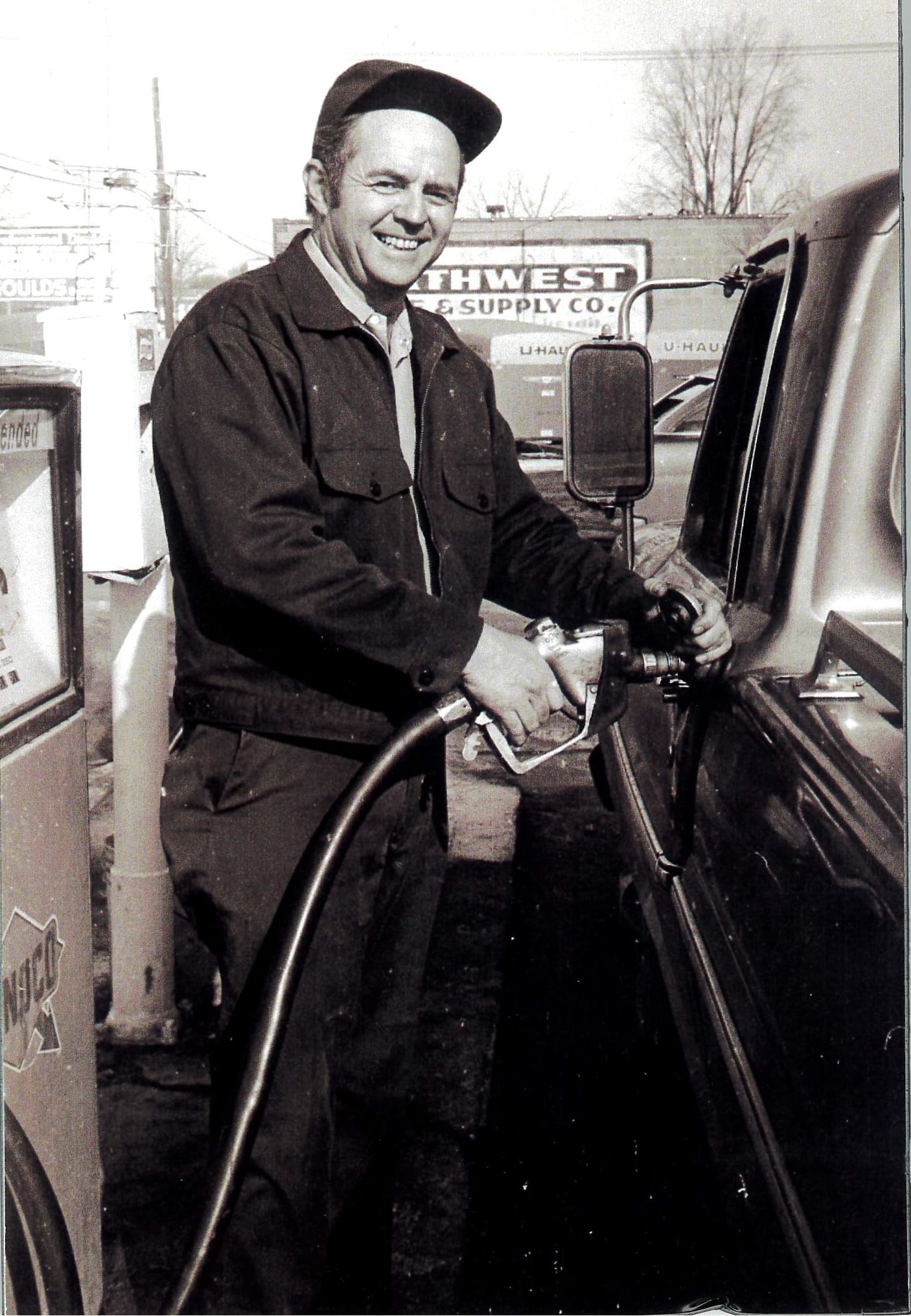 Bernie Corrigan pumping gas at a service station in the early days of Corrigan Oil