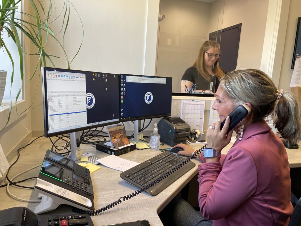 customer service woman on phone working on a computer